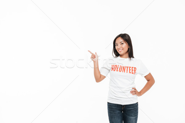 Portrait of a smiling joyful asian woman in volunteer t-shirt Stock photo © deandrobot