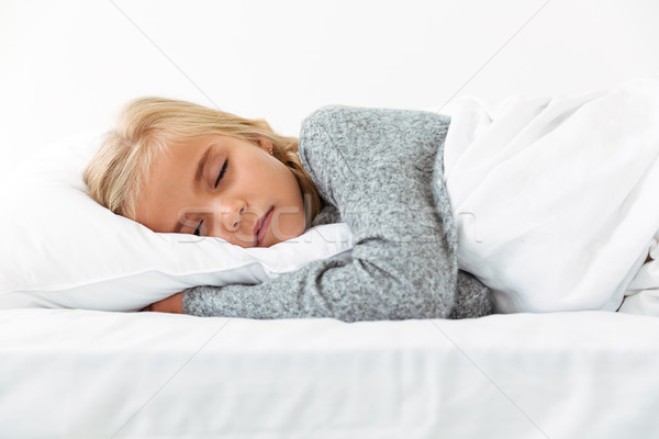  Cute little girl sleeping on white pillow in gray pajamas havin Stock photo © deandrobot