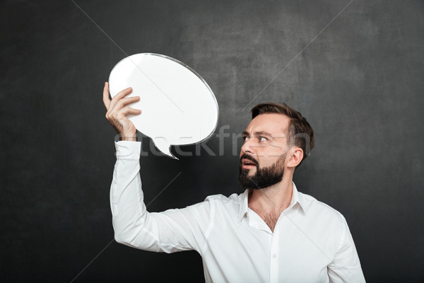 Close up photo of attractive man holding blank message ballon an Stock photo © deandrobot