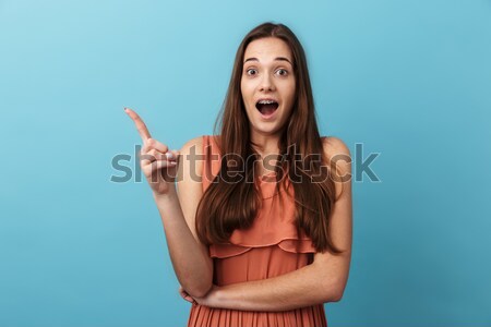 Picture of Joyful brunette woman posing and looking at camera Stock photo © deandrobot
