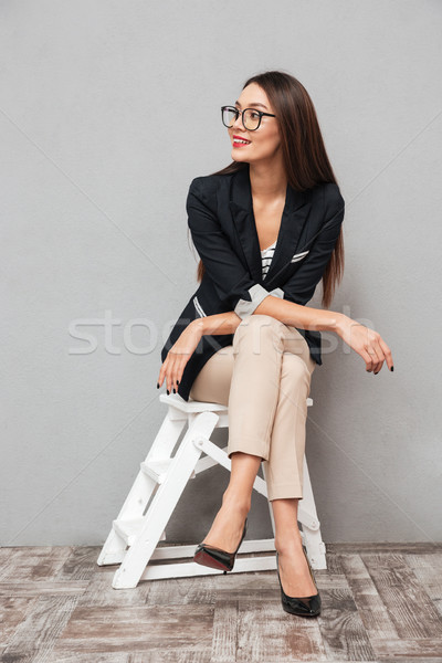 Vertical image souriant asian femme d'affaires lunettes [[stock_photo]] © deandrobot