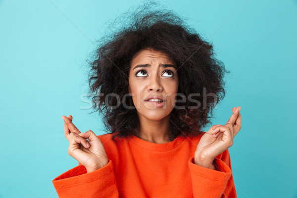 Portrait of praying young woman wearing casual begging god pleas Stock photo © deandrobot