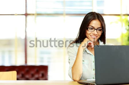 Smiling businesswoman standing next to flip board in office Stock photo © deandrobot