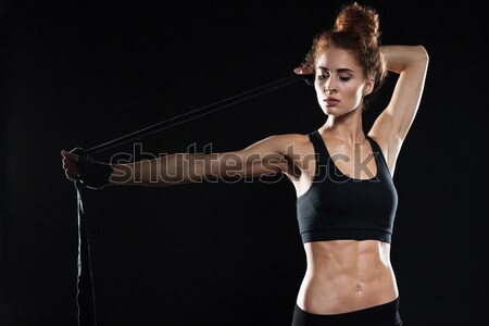 Smiling asian muscular man with arms stretched out on black background Stock photo © deandrobot