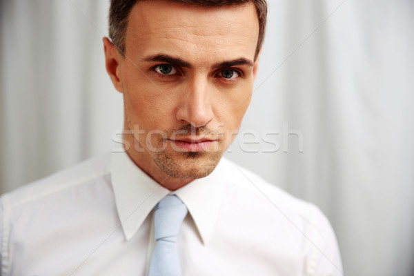 Portrait of a confident businessman in white shirt Stock photo © deandrobot