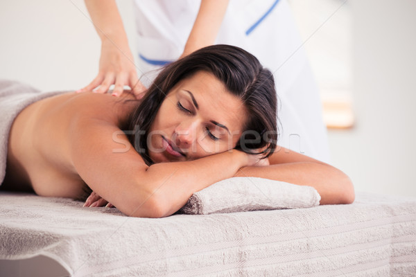 Relaxed woman lying on massage lounger Stock photo © deandrobot