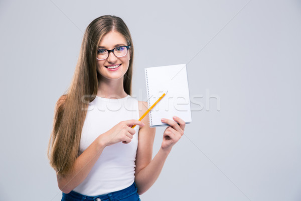 Mosolyog női tinédzser mutat notebook portré Stock fotó © deandrobot