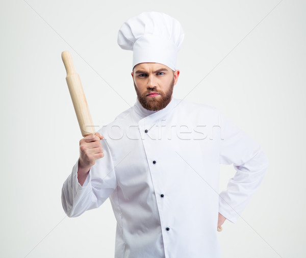 Serious male chef cook holding a rolling pin Stock photo © deandrobot
