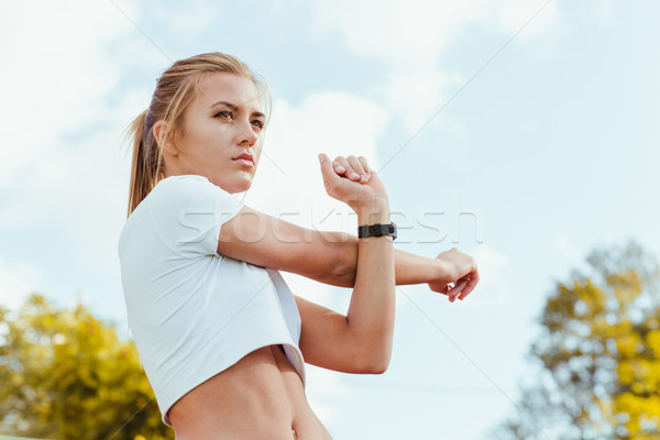 Fitness woman doing warm up exercises Stock photo © deandrobot