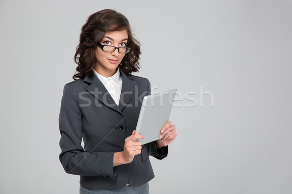 Young business woman in glases using tablet Stock photo © deandrobot