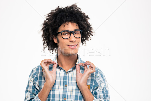 Funny afro american man in glasses holding collar of shirt Stock photo © deandrobot