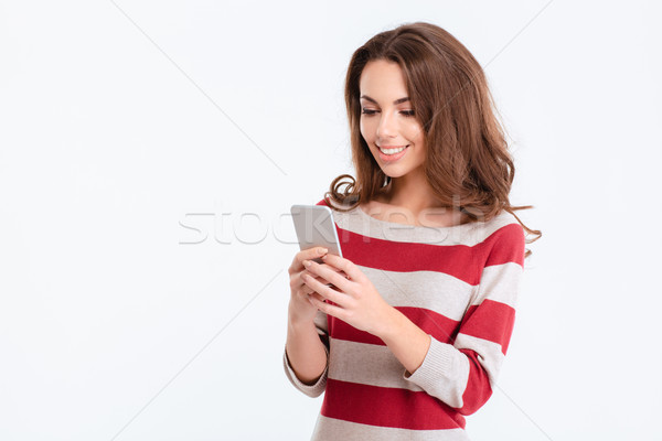 Heureux cute femme smartphone portrait isolé [[stock_photo]] © deandrobot