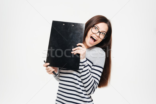 Cheerful woman peeking from clipboard Stock photo © deandrobot