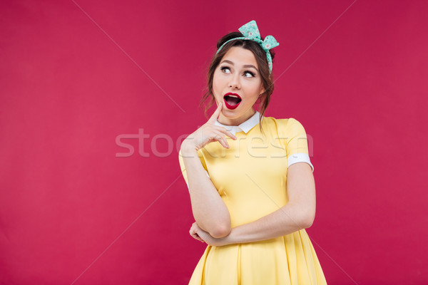 Mosolyog töprengő pinup lány citromsárga ruha Stock fotó © deandrobot