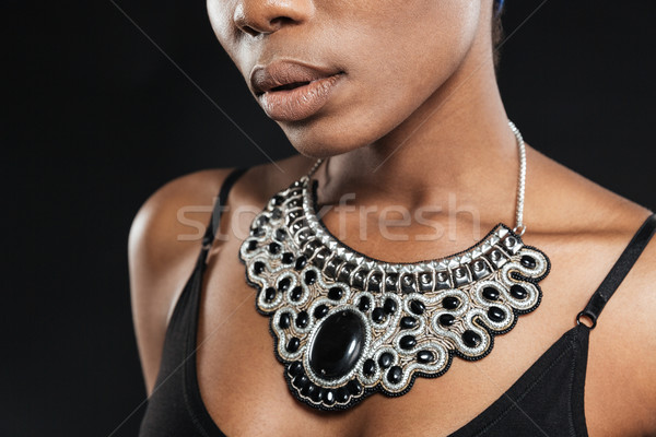 Cropped image of a beautiful african woman wearing necklace Stock photo © deandrobot