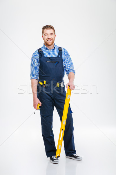 Full length portrait of a smiling male builder Stock photo © deandrobot