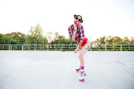 Legs of woman in swimsuit skating on roller skates outdoors Stock photo © deandrobot