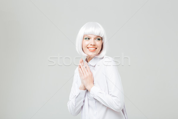 Portrait of cute smiling young woman in blonde wig Stock photo © deandrobot