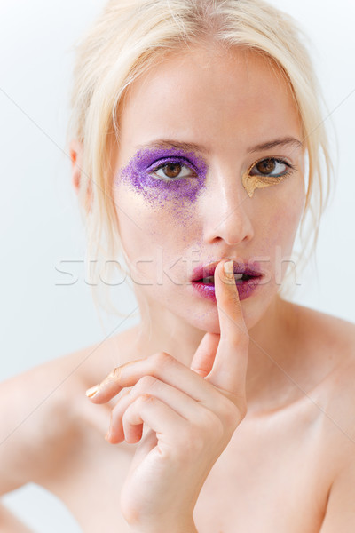 Portrait of sensual girl with creative makeup showing silence sign Stock photo © deandrobot