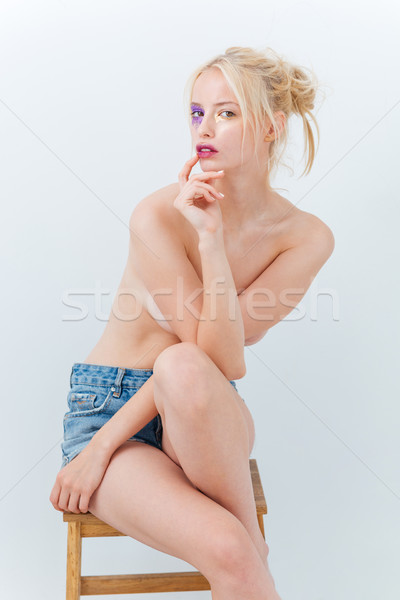 Attractive topless woman with bright purple makeup in jeans shorts Stock photo © deandrobot