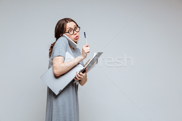 Young female nerd talking on phone Stock photo © deandrobot