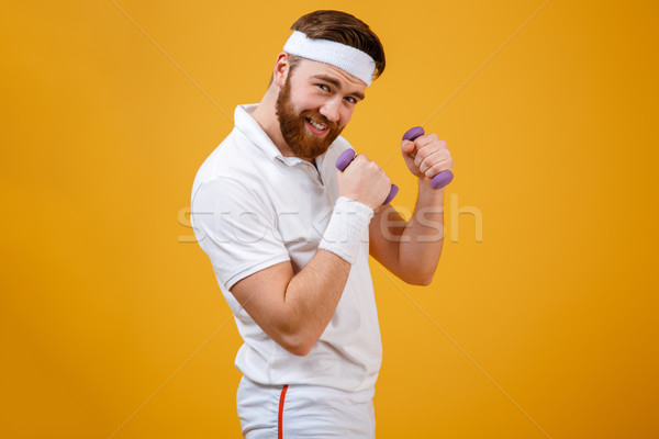 Sportoló áll tart könnyűsúlyú súlyzók kezek Stock fotó © deandrobot