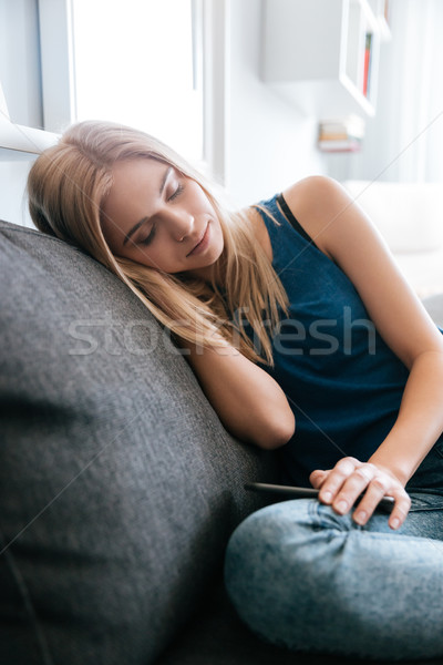 Cansado esgotado mulher jovem adormecido sofá casa Foto stock © deandrobot