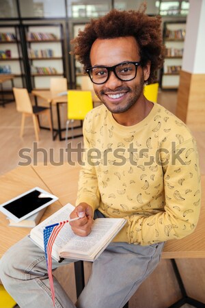 Attractive young asian man wearing glasses looking at camera Stock photo © deandrobot