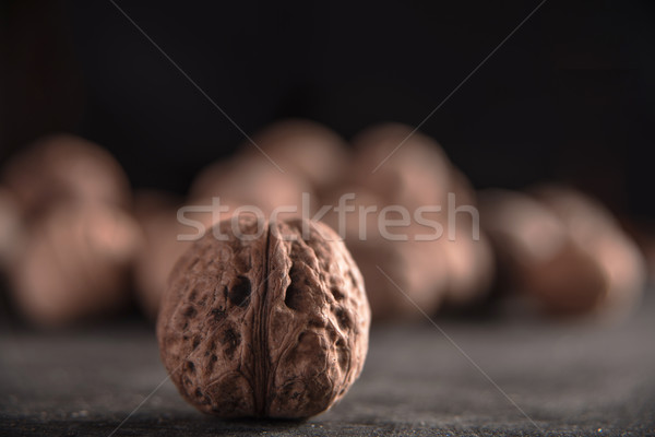 Walnuts over dark background Stock photo © deandrobot