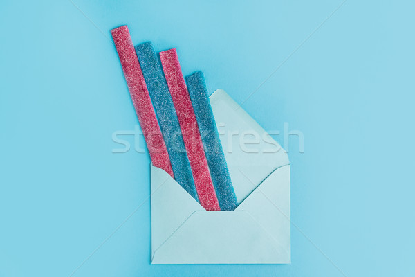 Top view of sugar stripes sticking out from an envelope Stock photo © deandrobot