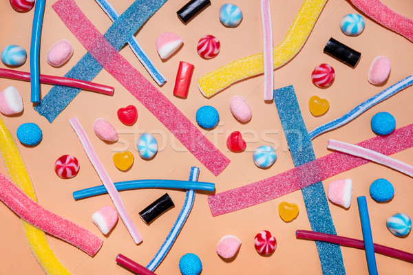 Top view of a mixed multicolored sweet candies and lollies Stock photo © deandrobot