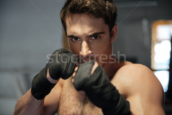 Young man boxer looking camera with hands Stock photo © deandrobot