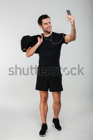 Derűs sportok férfi gyártmány táska mobiltelefon Stock fotó © deandrobot