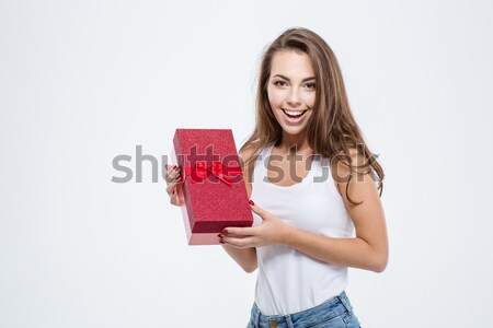 Cheerful caucasian woman standing isolated holding gifts. Stock photo © deandrobot