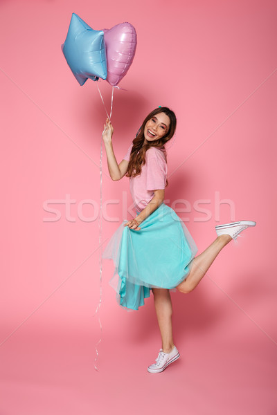 Full length portrait of a happy pretty girl Stock photo © deandrobot