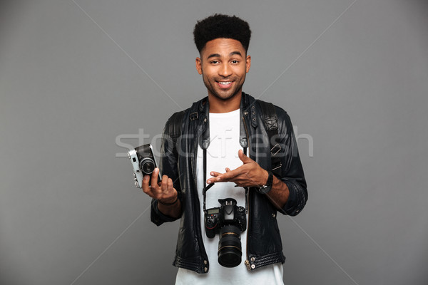 Portrait of a cheerful afro american guy in leather jacket Stock photo © deandrobot