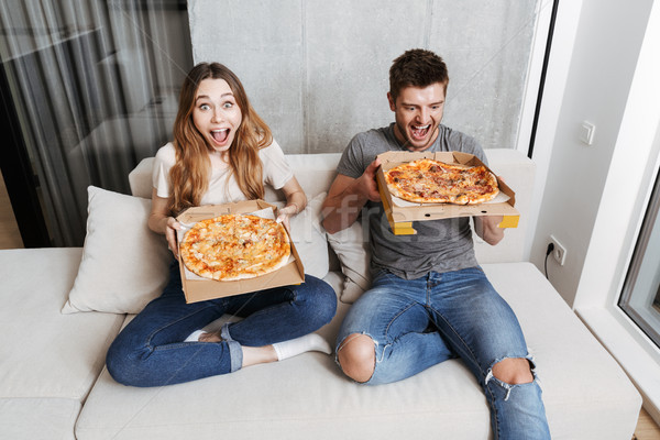 Happy young couple holding boxes with pizza Stock photo © deandrobot