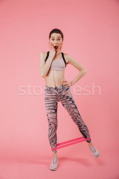 Full length image of Shocked sportswoman doing exercise Stock photo © deandrobot