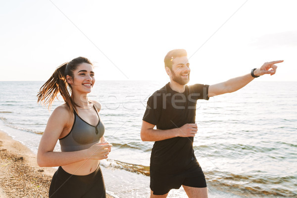 Boldog fiatal pér mutat messze jogging együtt Stock fotó © deandrobot
