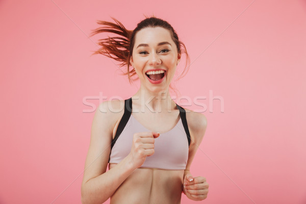Happy young fitness sports woman running isolated Stock photo © deandrobot
