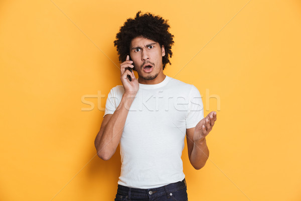 Portrait of an angry young african guy Stock photo © deandrobot