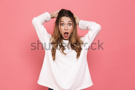Schockiert Brünette Frau Kleidung halten Stock foto © deandrobot