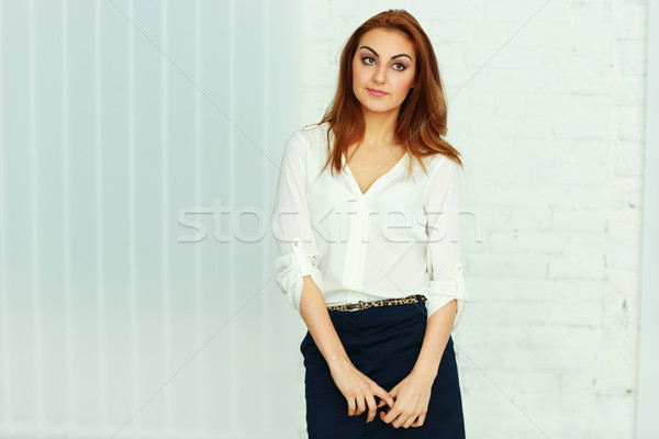 Tineri femeie de afaceri în picioare birou afaceri Imagine de stoc © deandrobot