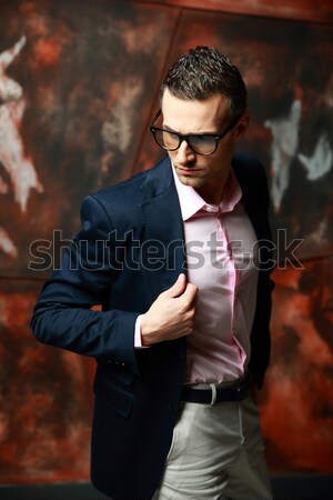 Cool fashion man standing over industrial background Stock photo © deandrobot
