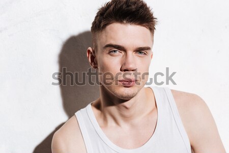 Handsome man removing eyebrow hairs with tweezing Stock photo © deandrobot