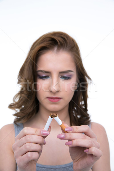 Beautiful woman breaking cigarette and no smoking concept. Focus on cigarette Stock photo © deandrobot