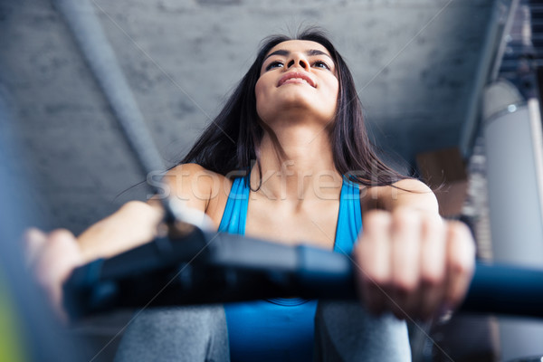 Smiling pretty woman working out at gym Stock photo © deandrobot