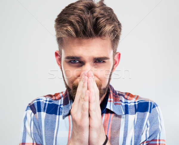 Portrait of a handsome man praying  Stock photo © deandrobot