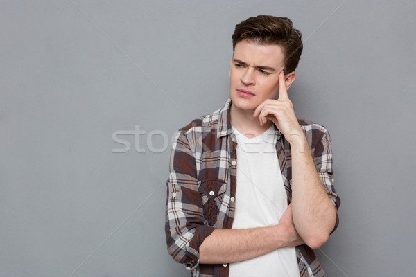 Stock photo: Concentrated pensive guy touching his temple