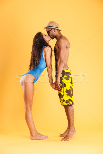 Loving young couple in swimwear kissing Stock photo © deandrobot